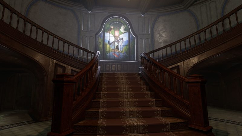 In a dark hallway light pours through a stained glass window on the landing of a large wooden staircase